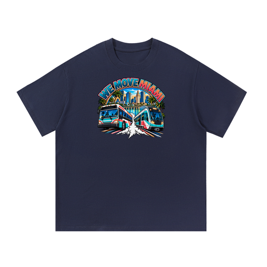We Move Miami Tee — navy heavyweight cotton with the MIA transit badge featuring the Miami skyline, Metromover, and bus, printed on the front.